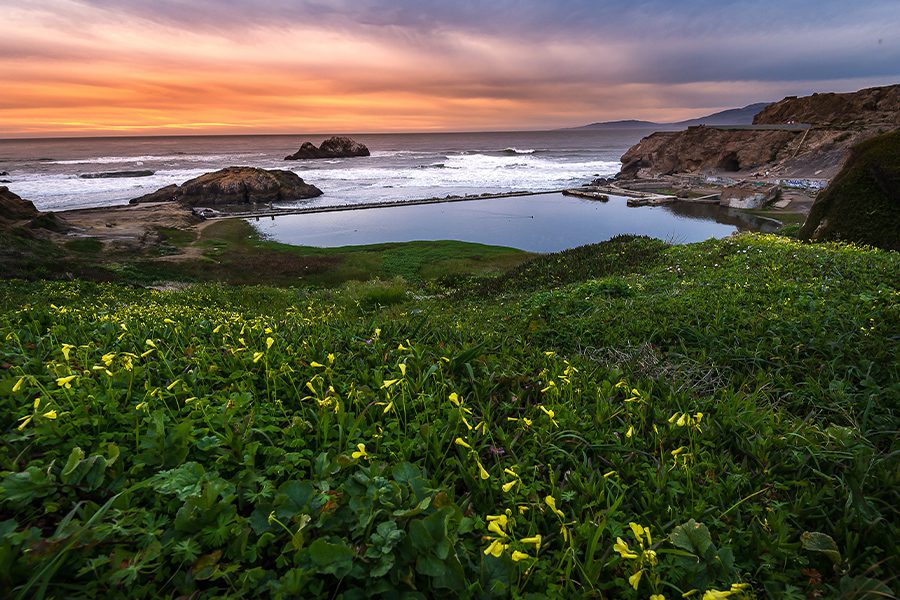 Contact - Sunset Over Rocks and Ocean Near Seal Beach in California